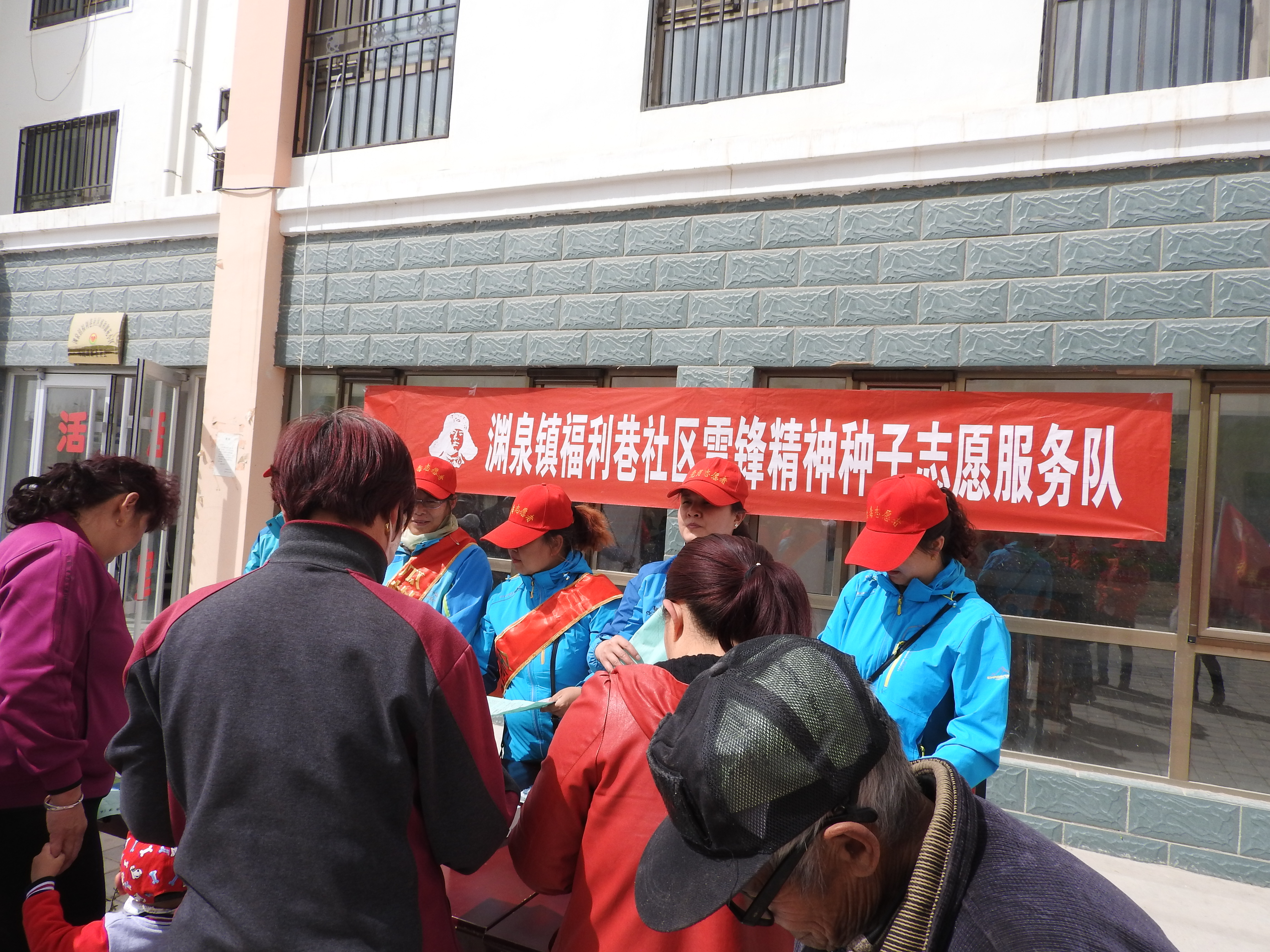 图为：蓝色志愿服务队为居民宣传禁毒、反邪教知识.JPG